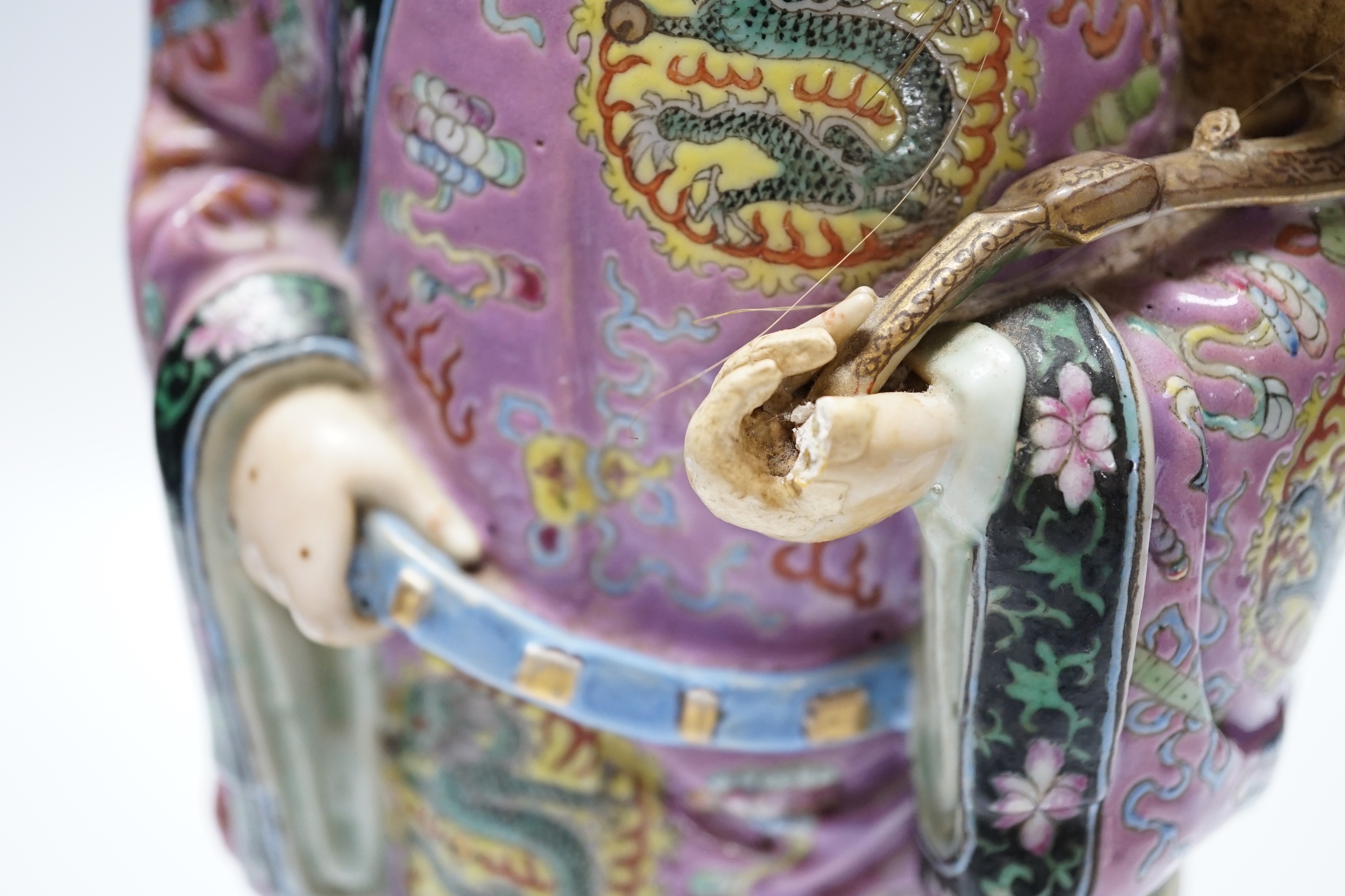 An early 20th century Chinese enamelled porcelain figure of an immortal, 31.5 cm high